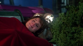 Movie still from “Masters of the Universe” (1987), directed by Gary Goddard – A woman laying on the ground with her eyes closed; Medium shot, High angle