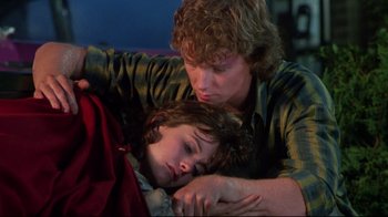 Movie still from “Masters of the Universe” (1987), directed by Gary Goddard – A young man and a young boy sleeping on a couch; Medium shot, Over the shoulder angle