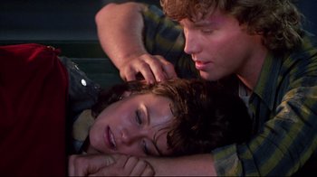 Movie still from “Masters of the Universe” (1987), directed by Gary Goddard – A man and a woman laying on the ground; Close Up shot, Overhead angle