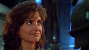 Movie still from “Masters of the Universe” (1987), directed by Gary Goddard – A person with long brown hair; Close Up shot, Low angle