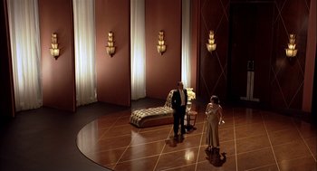 Movie still from “Match Point” (2005), directed by Woody Allen – A couple of people standing in a room with lights on; Extreme Wide shot, High angle