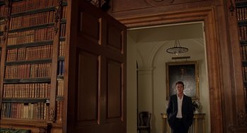Movie still from “Match Point” (2005), directed by Woody Allen – A man standing in front of an open door in a room; Wide shot, Low angle