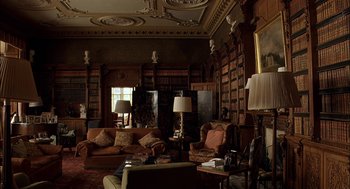 Movie still from “Match Point” (2005), directed by Woody Allen – A living room filled with lots of furniture and bookcases; Wide shot, High angle