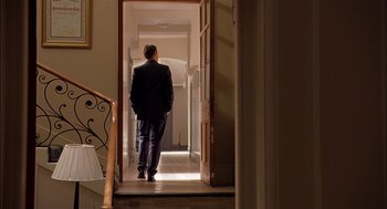 Movie still from “Match Point” (2005), directed by Woody Allen – A man in a suit walking down the hall way; Wide shot, Low angle