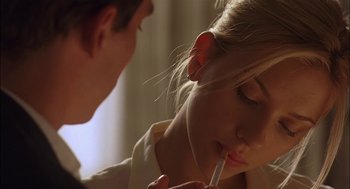 Movie still from “Match Point” (2005), directed by Woody Allen – A man is writing on a woman's face; Close Up shot, Over the shoulder angle