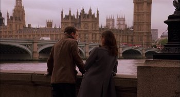 Movie still from “Match Point” (2005), directed by Woody Allen – A man and a woman standing next to each other on a bridge; Wide shot, Low angle