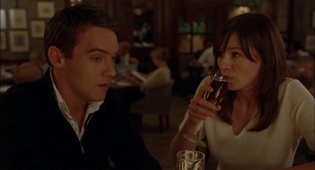 Movie still from “Match Point” (2005), directed by Woody Allen – A man and a woman sitting at a table with a glass of red wine; Close Up shot, Over the shoulder angle