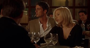 Movie still from “Match Point” (2005), directed by Woody Allen – A man and a woman sitting at a dinner table; Medium shot, Low angle