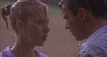 Movie still from “Match Point” (2005), directed by Woody Allen – A man and a woman standing next to each other in the rain; Close Up shot, Low angle