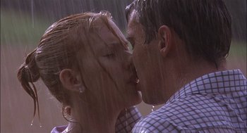 Movie still from “Match Point” (2005), directed by Woody Allen – A man and a woman kissing in the rain; Close Up shot, Low angle