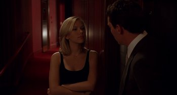 Movie still from “Match Point” (2005), directed by Woody Allen – A man and a woman standing next to each other in a room; Medium shot, Over the shoulder angle