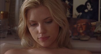 Movie still from “Match Point” (2005), directed by Woody Allen – A beautiful blonde woman with a necklace; Close Up shot, Low angle