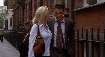 Movie still from “Match Point” (2005), directed by Woody Allen – A man and a woman standing next to each other on the sidewalk; Medium shot, Low angle