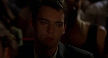 Movie still from “Match Point” (2005), directed by Woody Allen – A person wearing a suit and tie; Close Up shot, Over the shoulder angle