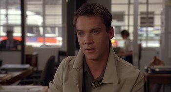 Movie still from “Match Point” (2005), directed by Woody Allen – A man that is wearing a tan jacket; Close Up shot, Over the shoulder angle