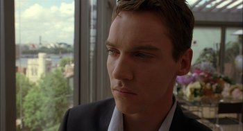 Movie still from “Match Point” (2005), directed by Woody Allen – A person wearing a suit and tie; Close Up shot, Over the shoulder angle