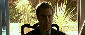 Movie still from “Matchstick Men” (2003), directed by Ridley Scott – A person wearing a suit and tie; Close Up shot, Low angle