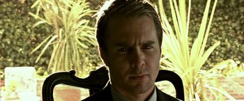 Movie still from “Matchstick Men” (2003), directed by Ridley Scott – A person wearing a suit and tie; Close Up shot, Low angle