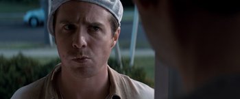 Movie still from “Matchstick Men” (2003), directed by Ridley Scott – A person wearing a hat; Close Up shot, Over the shoulder angle