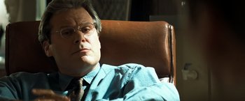 Movie still from “Matchstick Men” (2003), directed by Ridley Scott – A person wearing a suit and tie; Close Up shot, Low angle