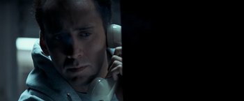 Movie still from “Matchstick Men” (2003), directed by Ridley Scott – A man holding a phone up to his ear; Close Up shot, Overhead angle