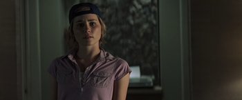 Movie still from “Matchstick Men” (2003), directed by Ridley Scott – A woman wearing a hat standing next to a window; Close Up shot, Over the shoulder angle