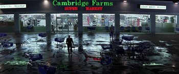 Movie still from “Matchstick Men” (2003), directed by Ridley Scott – A man in a suit walking in a store; Extreme Wide shot, High angle