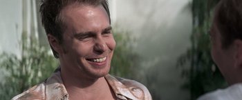 Movie still from “Matchstick Men” (2003), directed by Ridley Scott – A person smiling; Close Up shot, Over the shoulder angle