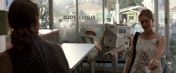 Movie still from “Matchstick Men” (2003), directed by Ridley Scott – A man sitting in front of a window reading a newspaper; Wide shot, High angle