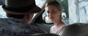 Movie still from “Matchstick Men” (2003), directed by Ridley Scott – A woman sitting in the back seat of a car talking to a man; Close Up shot, Over the shoulder angle