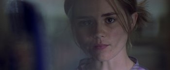 Movie still from “Matchstick Men” (2003), directed by Ridley Scott – A young woman's face in front of a window; Close Up shot, Over the shoulder angle
