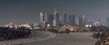 Movie still from “Matchstick Men” (2003), directed by Ridley Scott – A view of a city skyline from a distance; Extreme Wide shot, High angle
