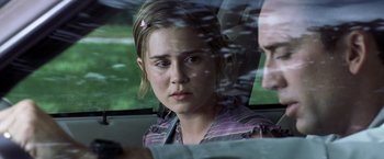 Movie still from “Matchstick Men” (2003), directed by Ridley Scott – A young woman sitting in the back seat of a car looking out the window; Close Up shot, Over the shoulder angle