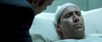 Movie still from “Matchstick Men” (2003), directed by Ridley Scott – A man in a hospital bed talking to a doctor; Close Up shot, Over the shoulder angle