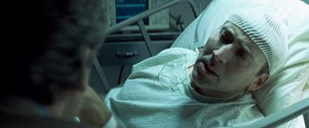 Movie still from “Matchstick Men” (2003), directed by Ridley Scott – A man laying in a hospital bed looking at a monitor; Close Up shot, High angle