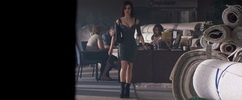 Movie still from “Matchstick Men” (2003), directed by Ridley Scott – A woman in a black dress is walking in a restaurant; Wide shot, Low angle