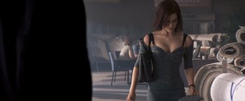 Movie still from “Matchstick Men” (2003), directed by Ridley Scott – A woman walking in a room holding a purse; Medium shot, Over the shoulder angle