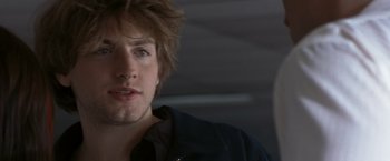 Movie still from “Matchstick Men” (2003), directed by Ridley Scott – A person wearing a black shirt; Close Up shot, Over the shoulder angle