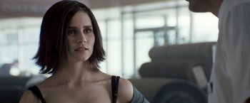 Movie still from “Matchstick Men” (2003), directed by Ridley Scott – A beautiful woman with short hair looking at the camera; Close Up shot, Over the shoulder angle