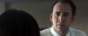 Movie still from “Matchstick Men” (2003), directed by Ridley Scott – A person wearing a shirt and tie; Close Up shot, Over the shoulder angle