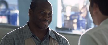 Movie still from “Matchstick Men” (2003), directed by Ridley Scott – A person wearing a plaid shirt; Close Up shot, Low angle