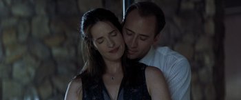 Movie still from “Matchstick Men” (2003), directed by Ridley Scott – A man and a woman embracing each other in the dark; Close Up shot, Low angle