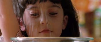 Movie still from “Matilda” (1996), directed by Danny DeVito – A child's face looking at the camera; Extreme Close Up shot, High angle