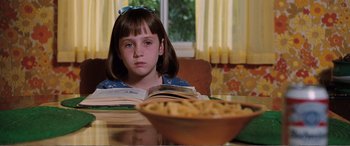 Movie still from “Matilda” (1996), directed by Danny DeVito – A girl sitting at a table with a bowl of cereal; Close Up shot, High angle