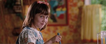 Movie still from “Matilda” (1996), directed by Danny DeVito – A little girl holding a pencil in her hand; Close Up shot, High angle