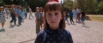 Movie still from “Matilda” (1996), directed by Danny DeVito – A little girl standing in front of a group of other children; Close Up shot, Over the shoulder angle