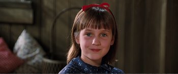 Movie still from “Matilda” (1996), directed by Danny DeVito – A young girl with a red bow in her hair; Close Up shot, High angle