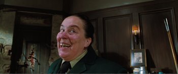Movie still from “Matilda” (1996), directed by Danny DeVito – A woman in a green jacket is laughing; Close Up shot, Low angle