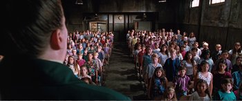 Movie still from “Matilda” (1996), directed by Danny DeVito – A large group of children sitting in a room; Wide shot, High angle