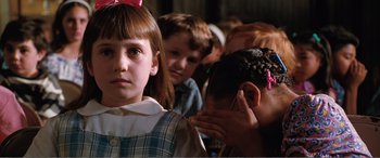Movie still from “Matilda” (1996), directed by Danny DeVito – A group of children sitting in a room; Close Up shot, Over the shoulder angle